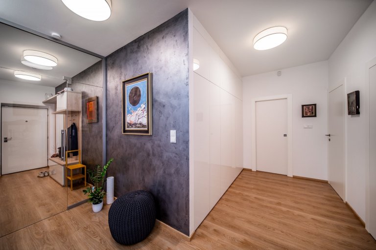 Moderní byt pro manželský pár, který miluje umění.&nbsp; Bytem se prolíná kontrast bílé a antracitu s doplňujícím dubem a betonovými prvky.
