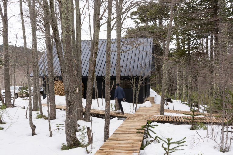 Chata uprostřed zasněženého lesa