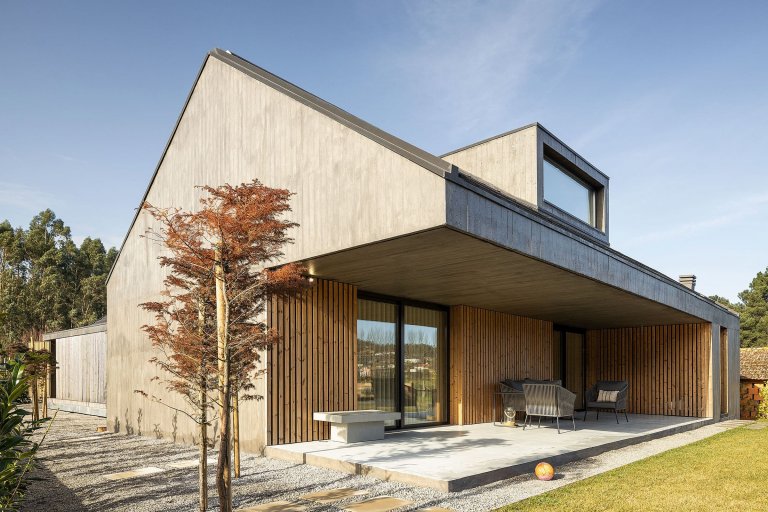 Dům s dřevěnou fasádou a geometrickými světlíky