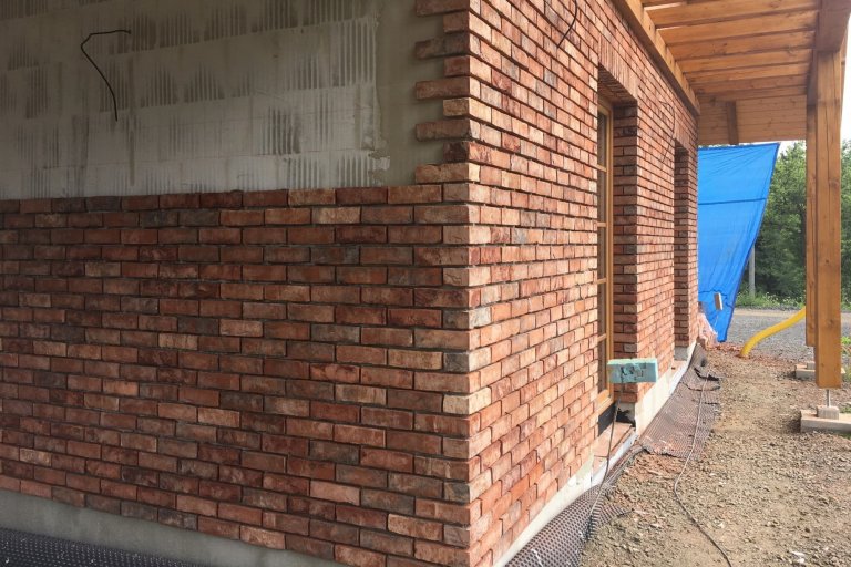 Montáž cihlových pásků obkladu domu