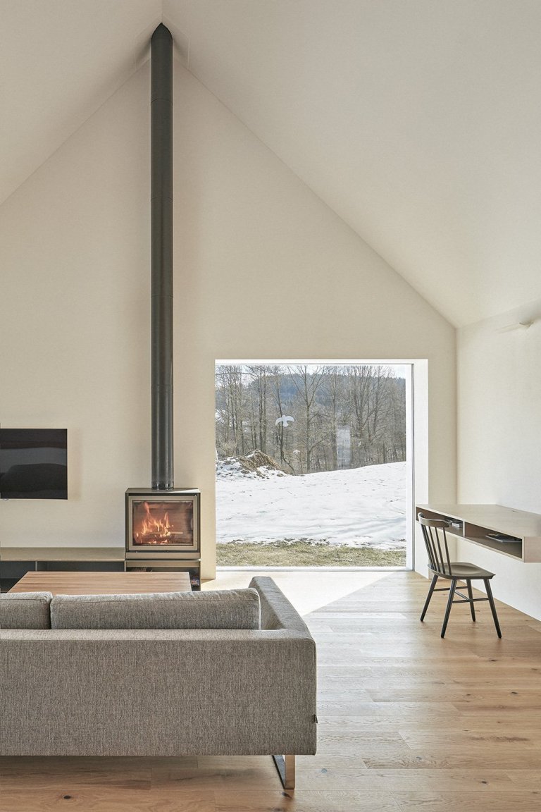 Pozemek leží na hraně svahu v&nbsp;centru malé obce na Vysočině. Na půdorysné stopě bývalého statku vznikl dům a stodola. Dům má podél jihozápadní fasády kryté…