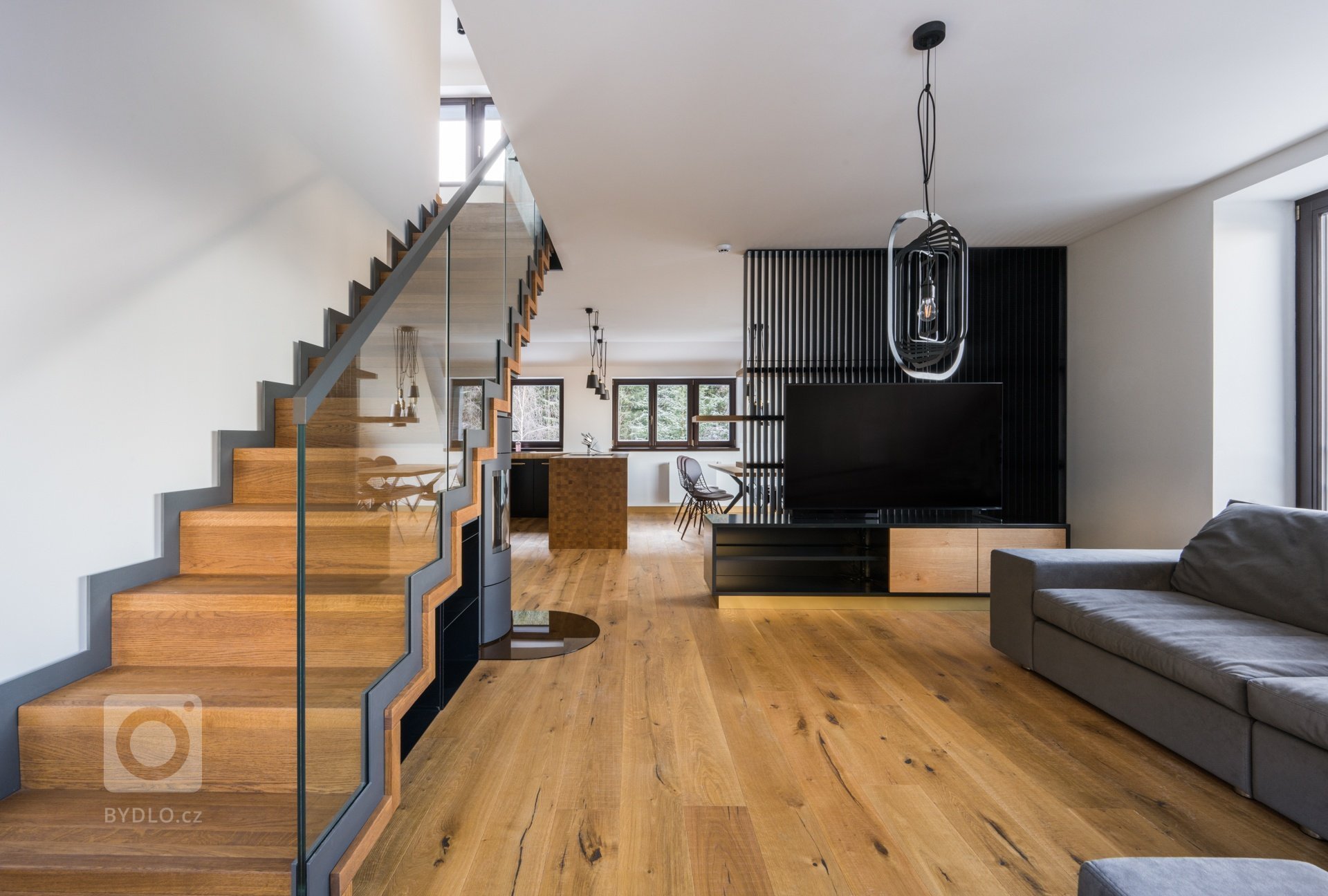 Koncept interiéru je laděn do přírodních materiálů a tmavších barev v&nbsp;kombinaci s&nbsp;bronzem, alcantarou a koňakovou kůží. Podlaha je až na koupelny…