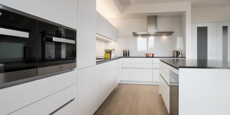 Kuchyň EGGERSMANN, byt, realizace 2018. Provedení je melamin Tarent 2700 KU bílá mat, bezúchytkový systém e:sing hliník, doplňky Blanco. Pracovní deska je žula…